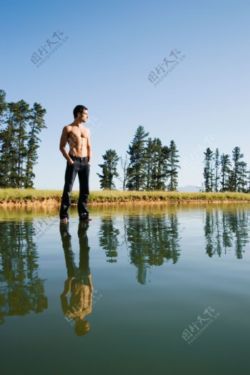 站立在水面上看向远方的男人图片