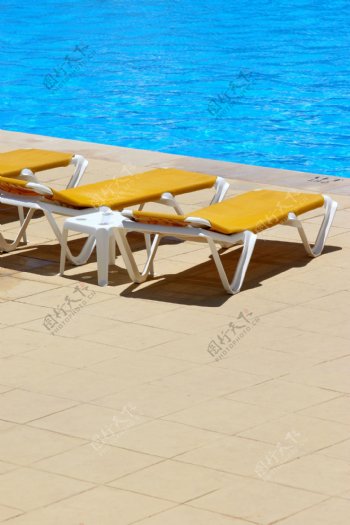 游泳池边的休闲椅图片