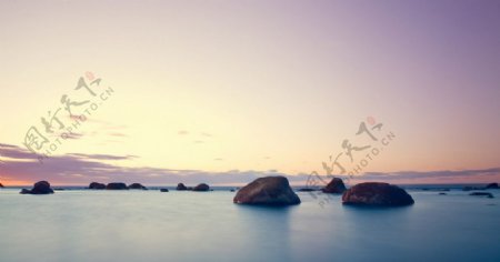 沿海海边岩石夕阳图片
