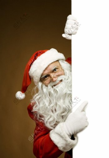手指着空白广告牌的圣诞老人图片