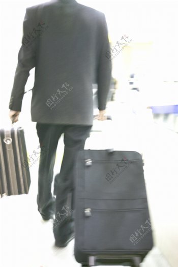 拖着行李箱的男人图片