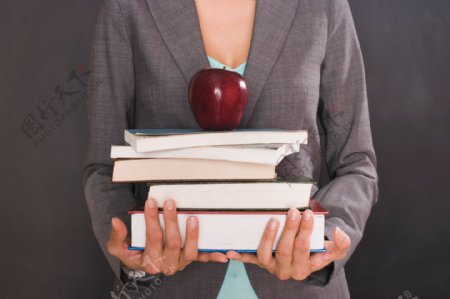 抱着书本苹果的职业女性图片